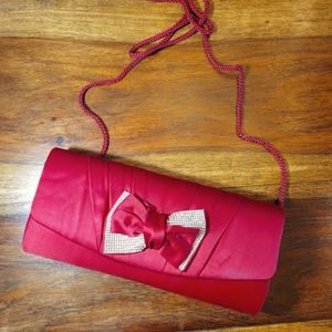Red satin evening bag with shoulder strap.